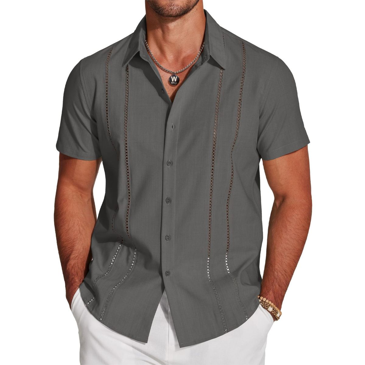 Man wearing a gray short-sleeve shirt with decorative stitching on a white background