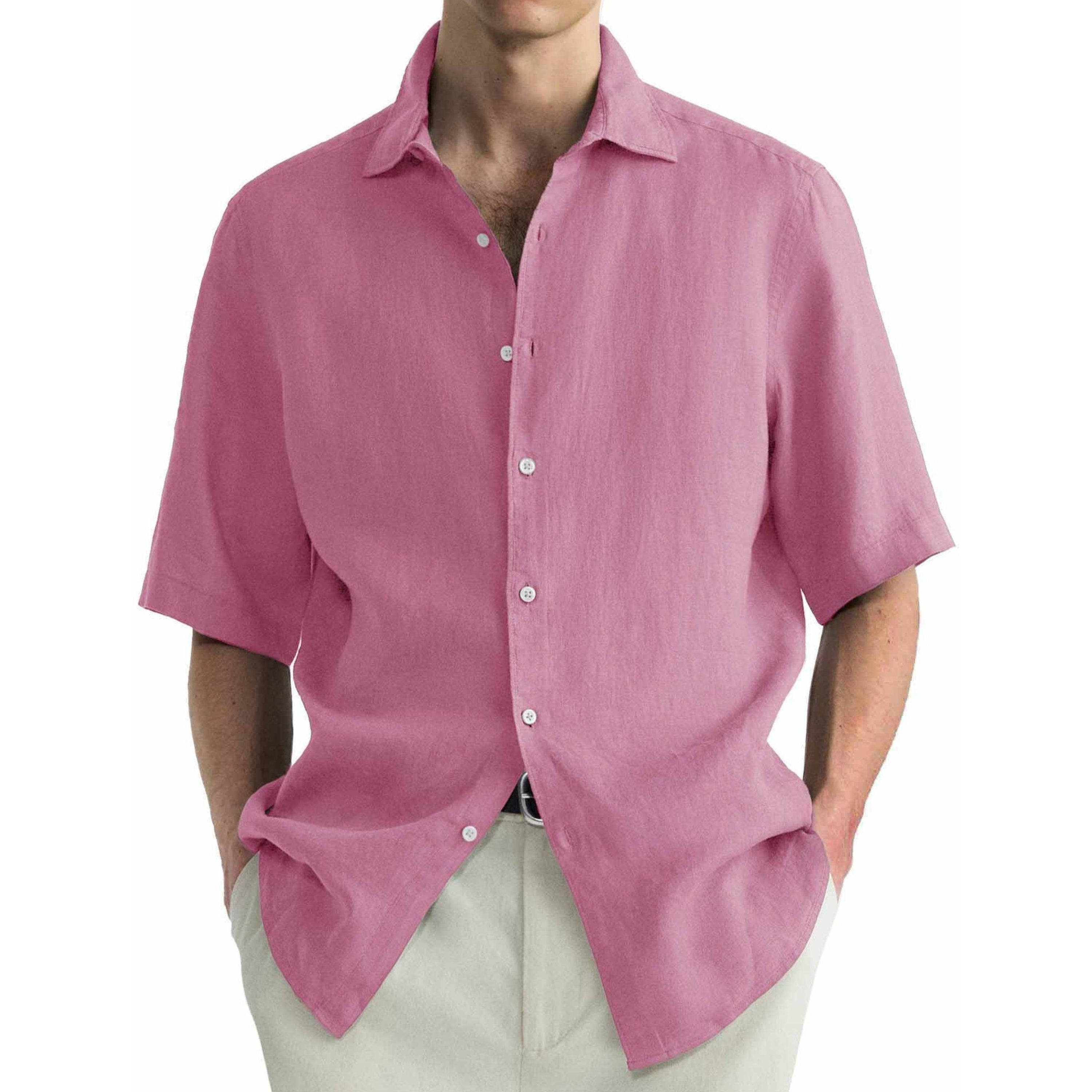 Pink short-sleeve shirt worn by a person on a white background.