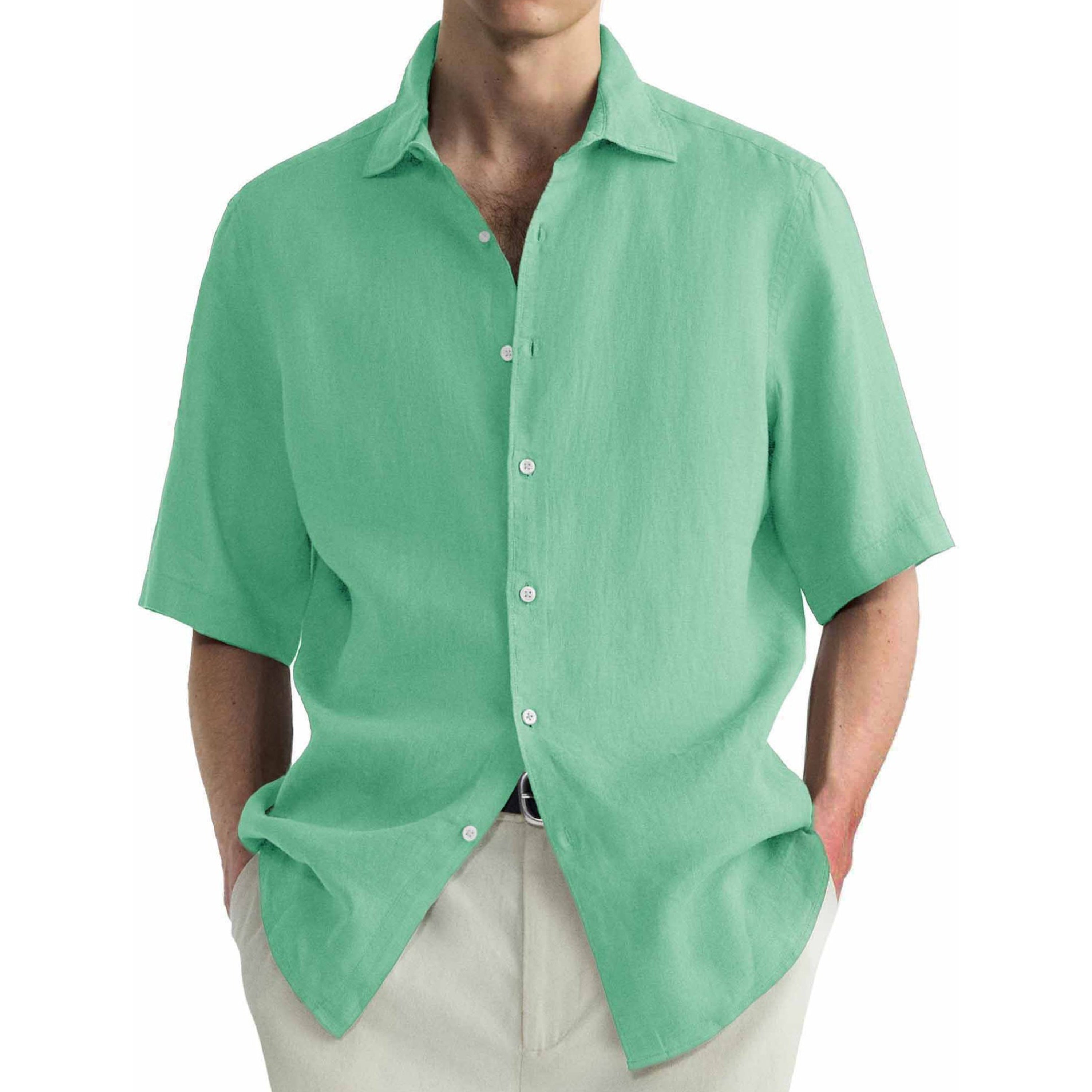 Green short-sleeve shirt worn by a person on a white background
