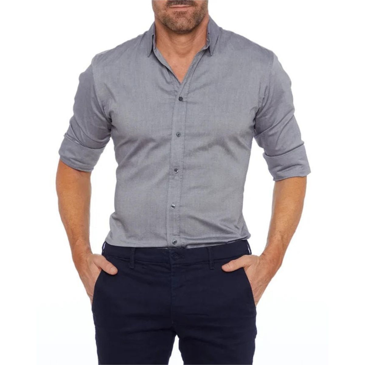 Man wearing a gray button-up shirt and navy pants on a white background