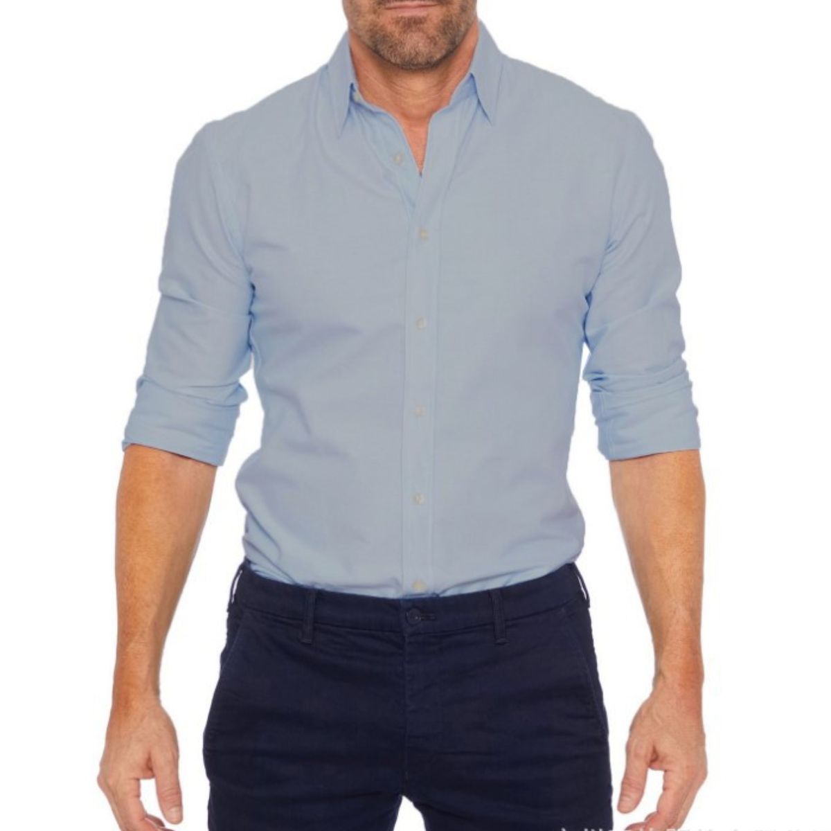 Man wearing a light blue button-up shirt and dark pants on a white background