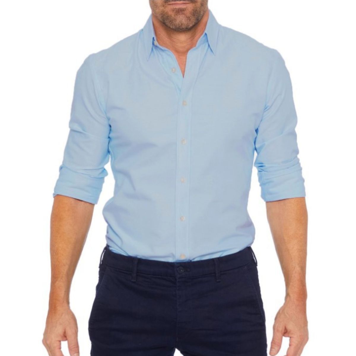Man wearing a light blue button-up shirt with rolled-up sleeves on a white background