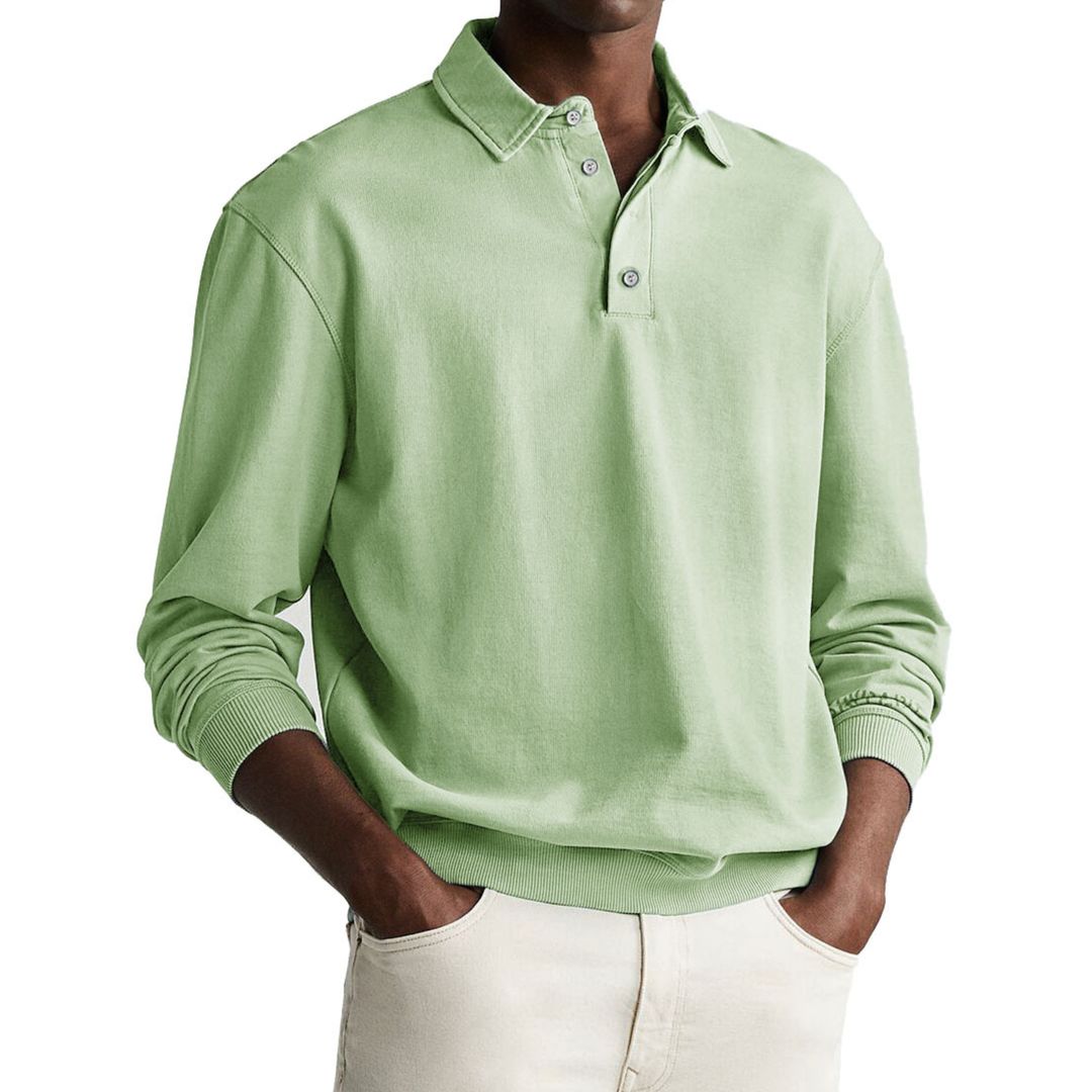 A man wearing a gray long-sleeve polo sweatshirt with a collar and a three-button placket.