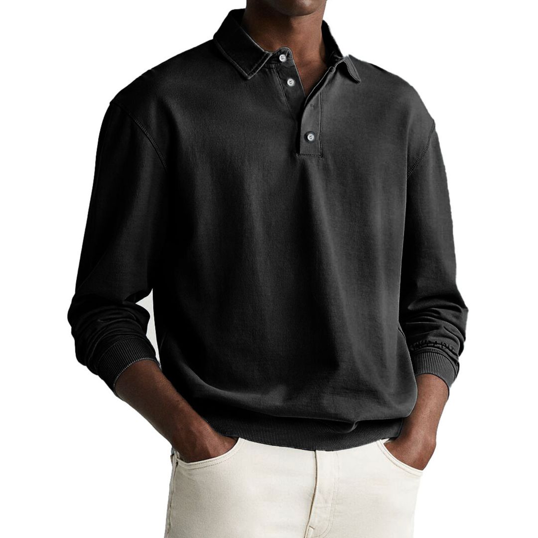 A man wearing a gray long-sleeve polo sweatshirt with a collar and a three-button placket.
