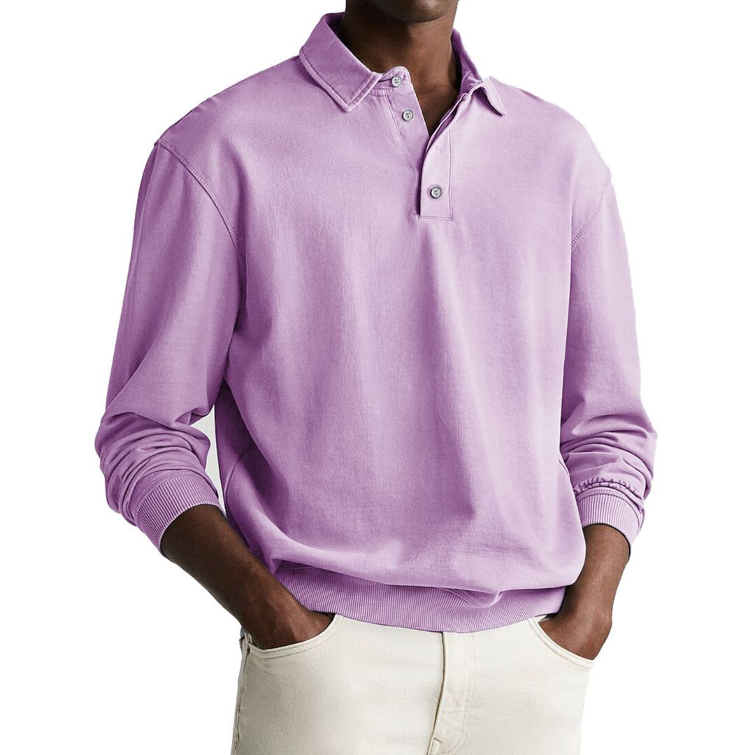 A man wearing a gray long-sleeve polo sweatshirt with a collar and a three-button placket.