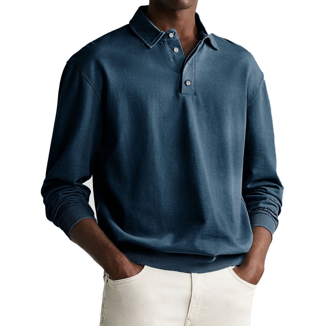A man wearing a gray long-sleeve polo sweatshirt with a collar and a three-button placket.