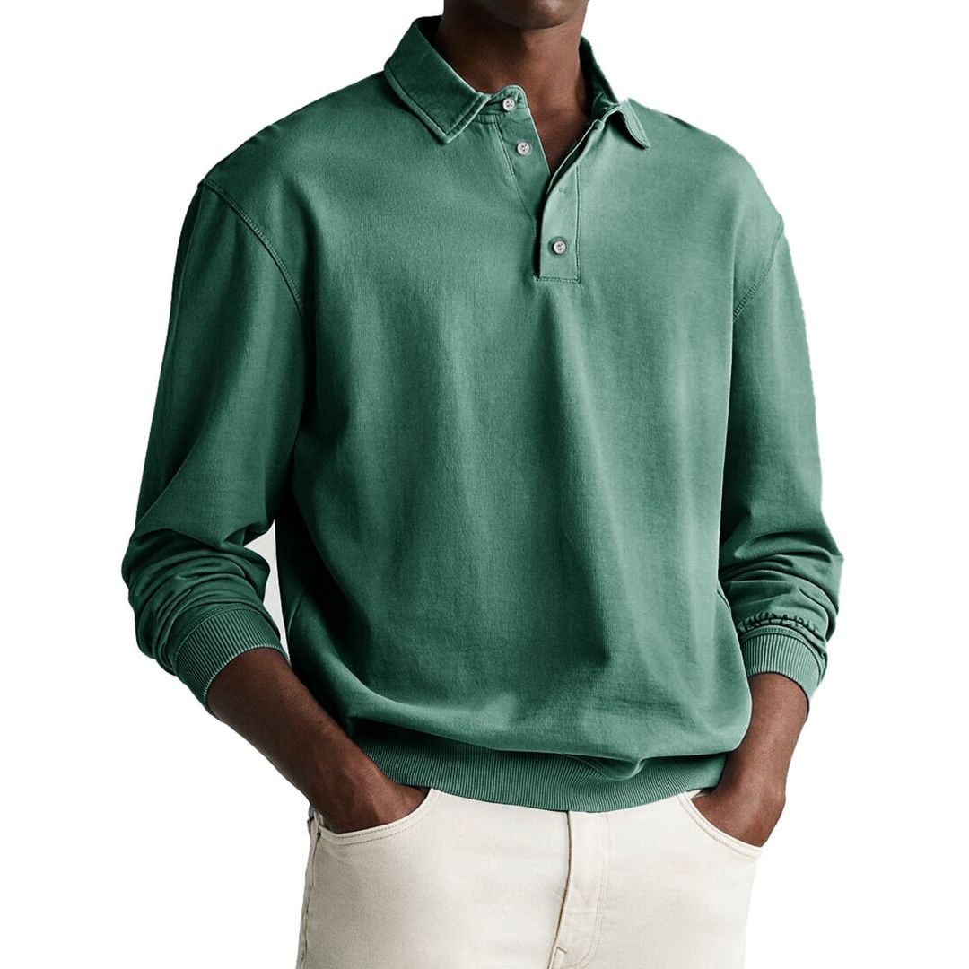 A man wearing a gray long-sleeve polo sweatshirt with a collar and a three-button placket.