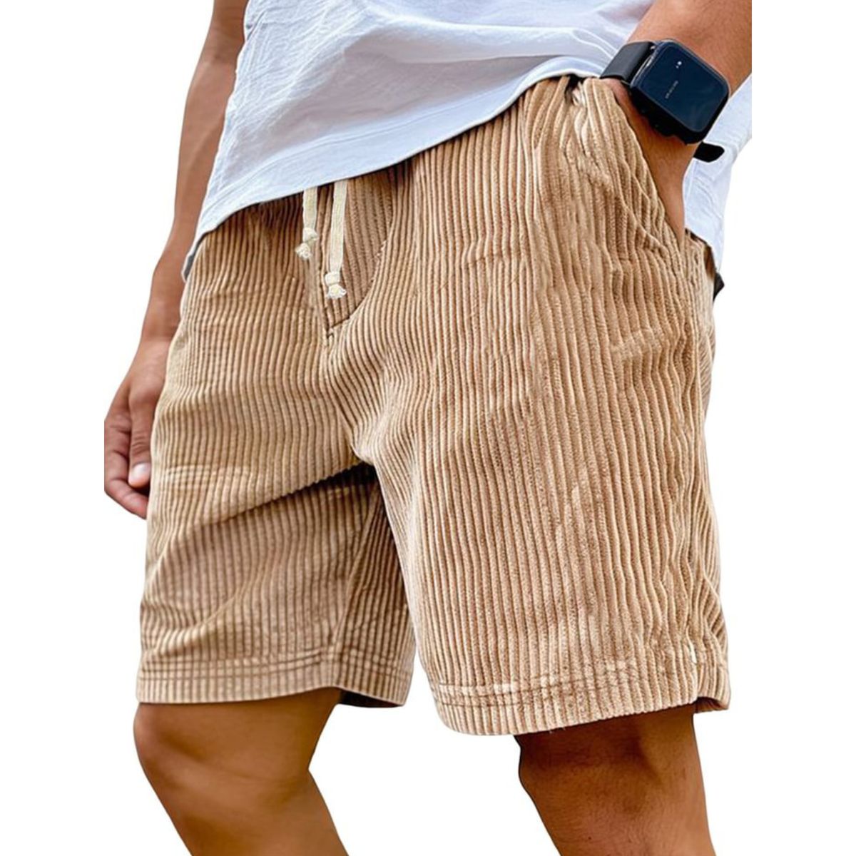 Beige corduroy shorts worn by a person on a white background