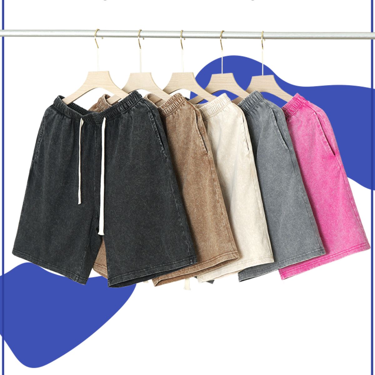 Set of shorts in various colors hanging on a rack against a blue and white background