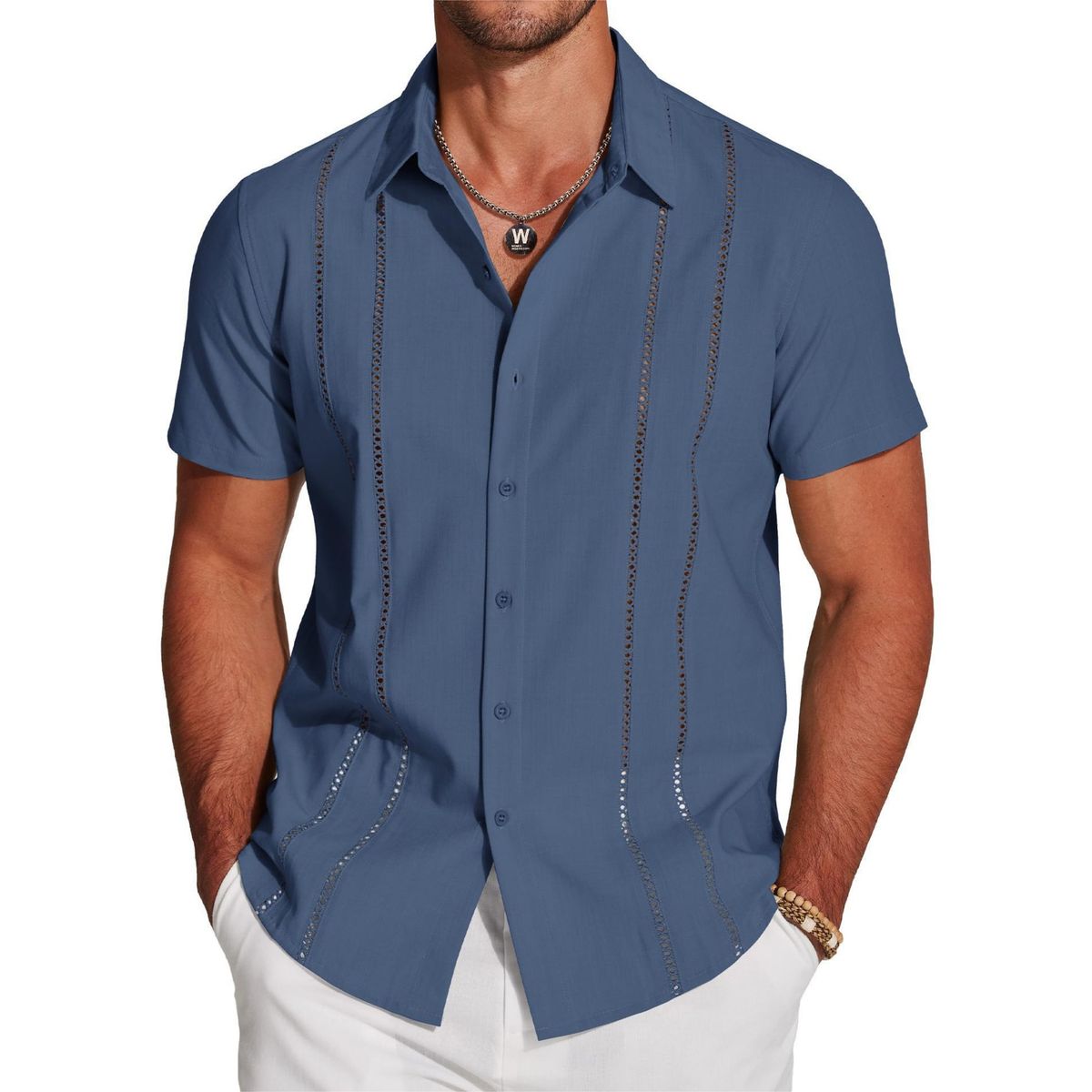 Man wearing a blue short-sleeve shirt with decorative stitching on a white background
