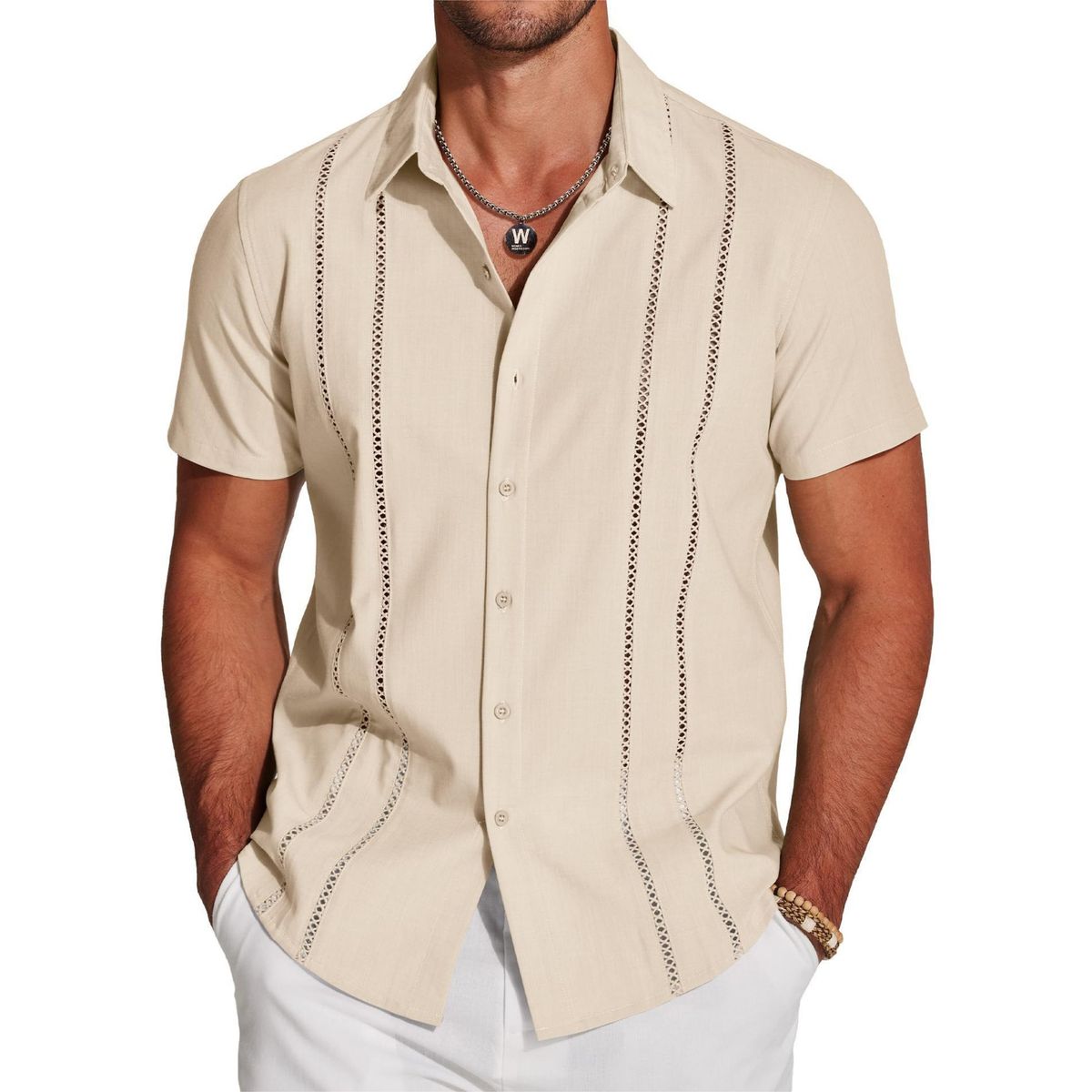 Man wearing a beige short-sleeve button-up shirt with decorative stitching on a white background