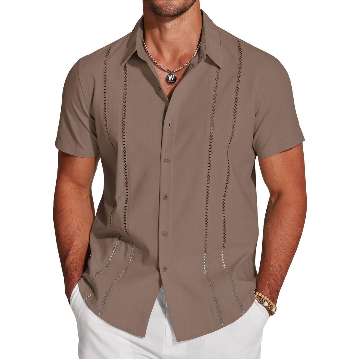 Man wearing a brown short-sleeve shirt with decorative stitching on a white background