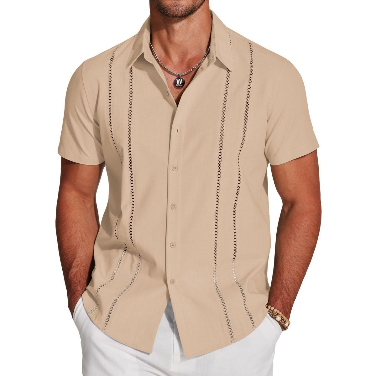 Man wearing a beige short-sleeve shirt with decorative stitching on a white background