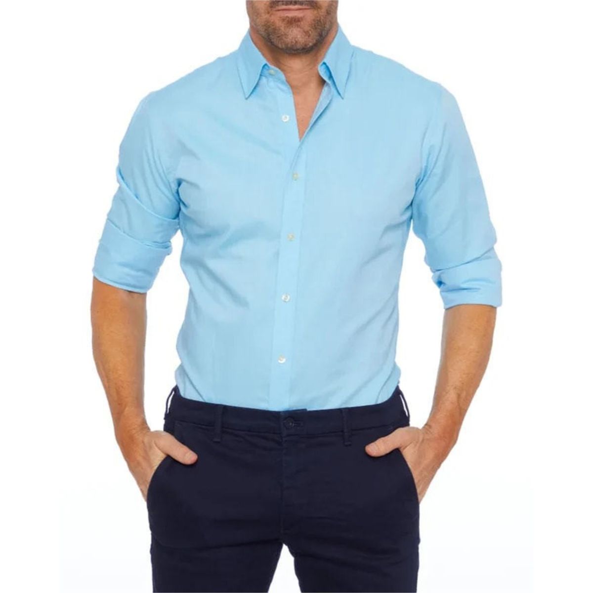Man wearing a light blue button-up shirt and dark pants on a white background