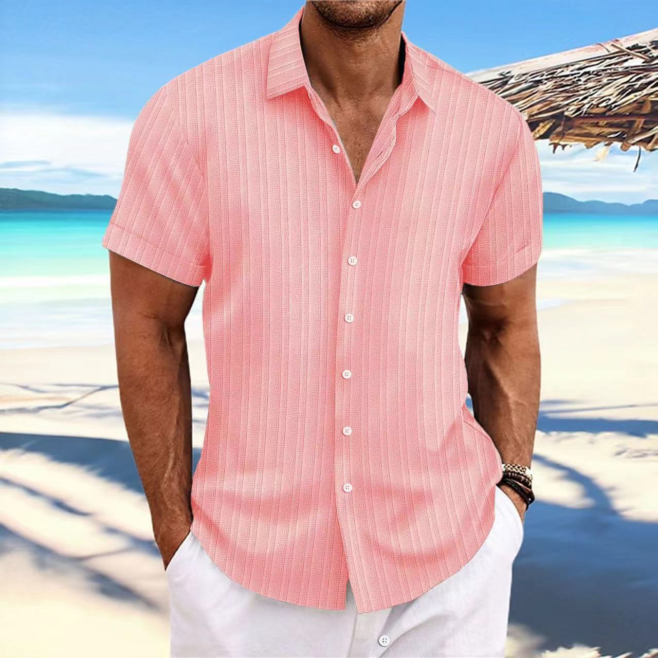 Man wearing a pink striped shirt on a beach