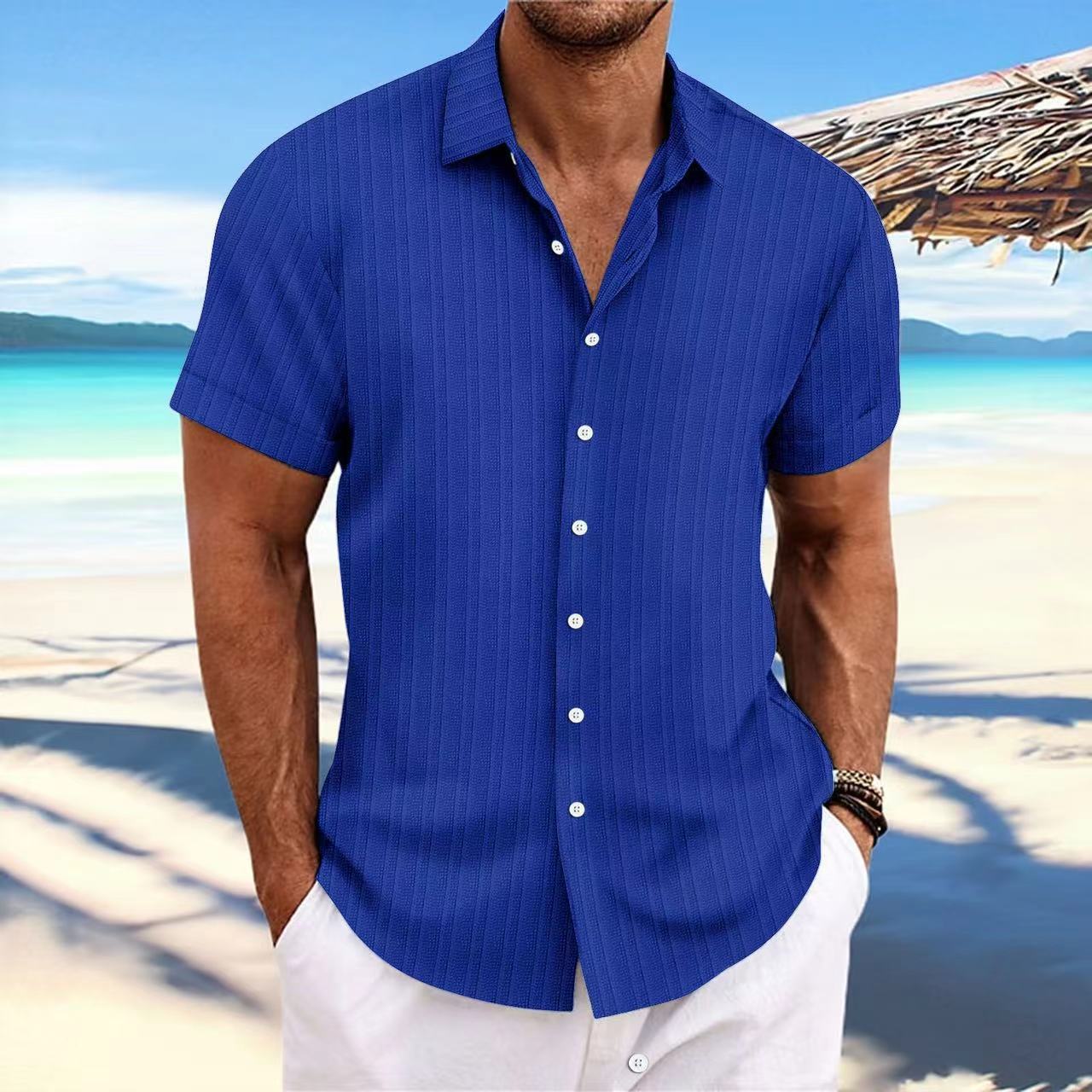Man wearing a blue striped shirt on a beach
