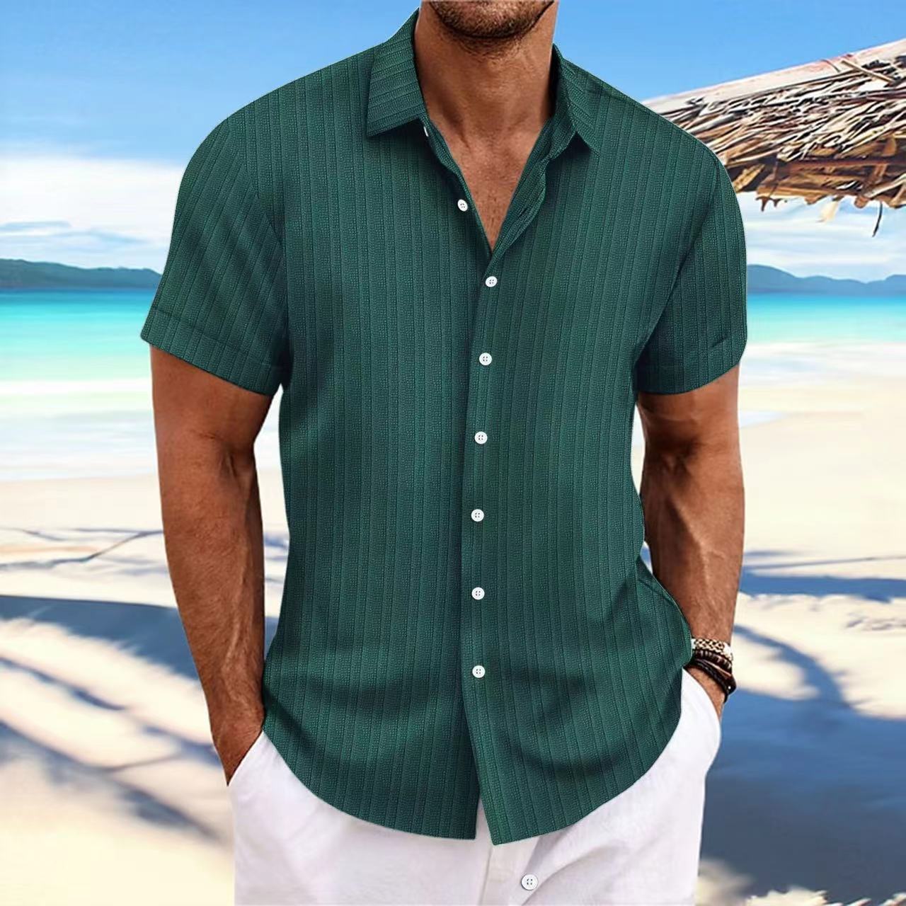 Man wearing a green striped shirt on a beach