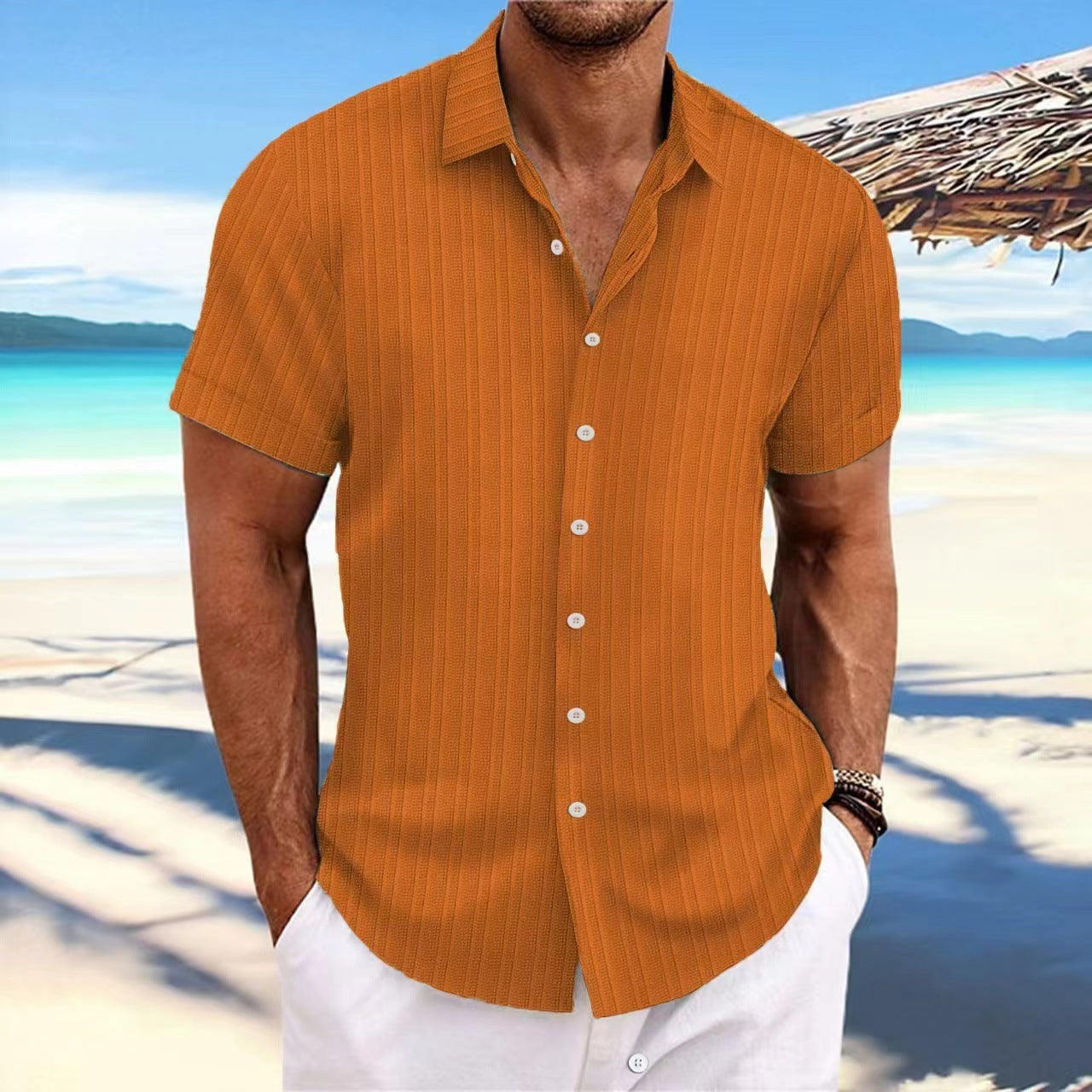 Man wearing an orange striped shirt on a beach
