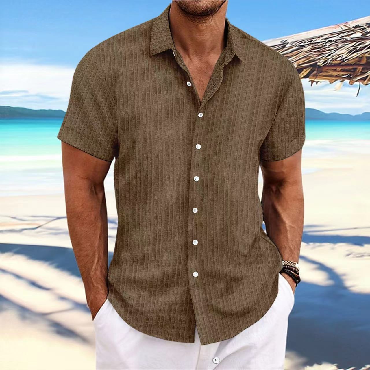 Man wearing a brown striped shirt on a beach