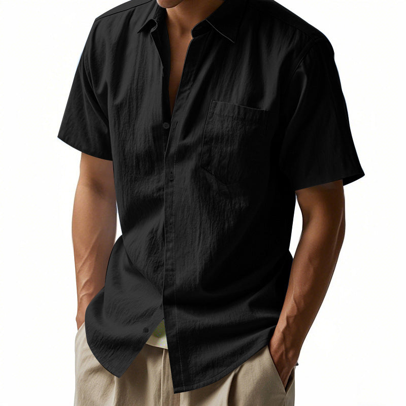 Black short-sleeve shirt worn by a person on a white background