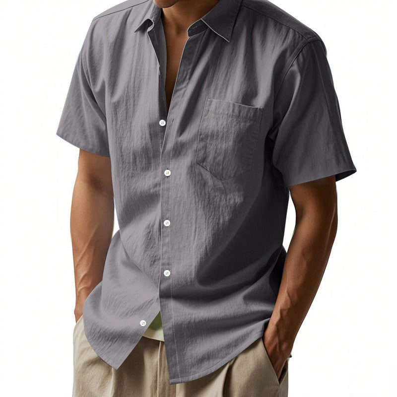 Gray short-sleeve shirt worn by a person on a white background