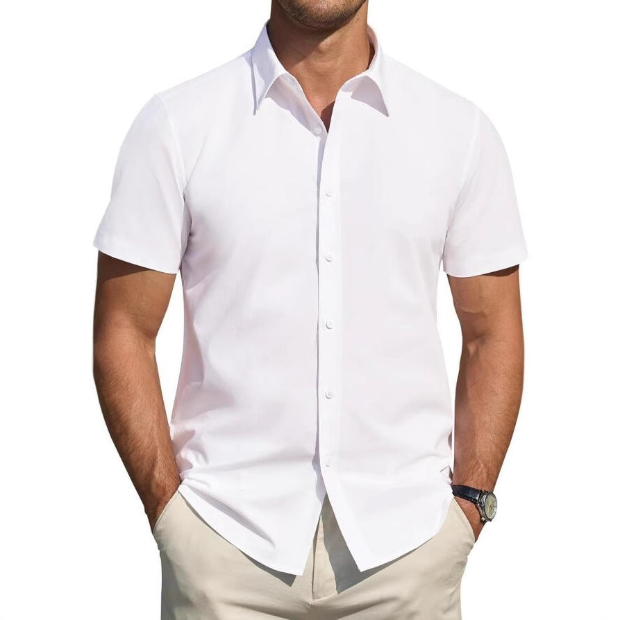 Man wearing a white short-sleeve shirt and beige pants on a white background