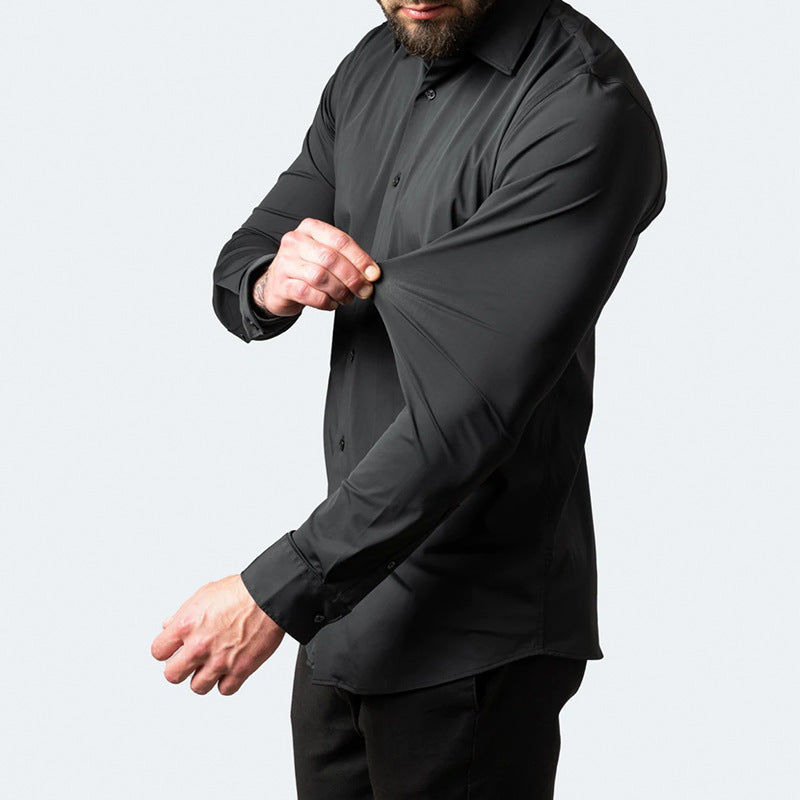 Man wearing a black shirt and pants against a light gray background