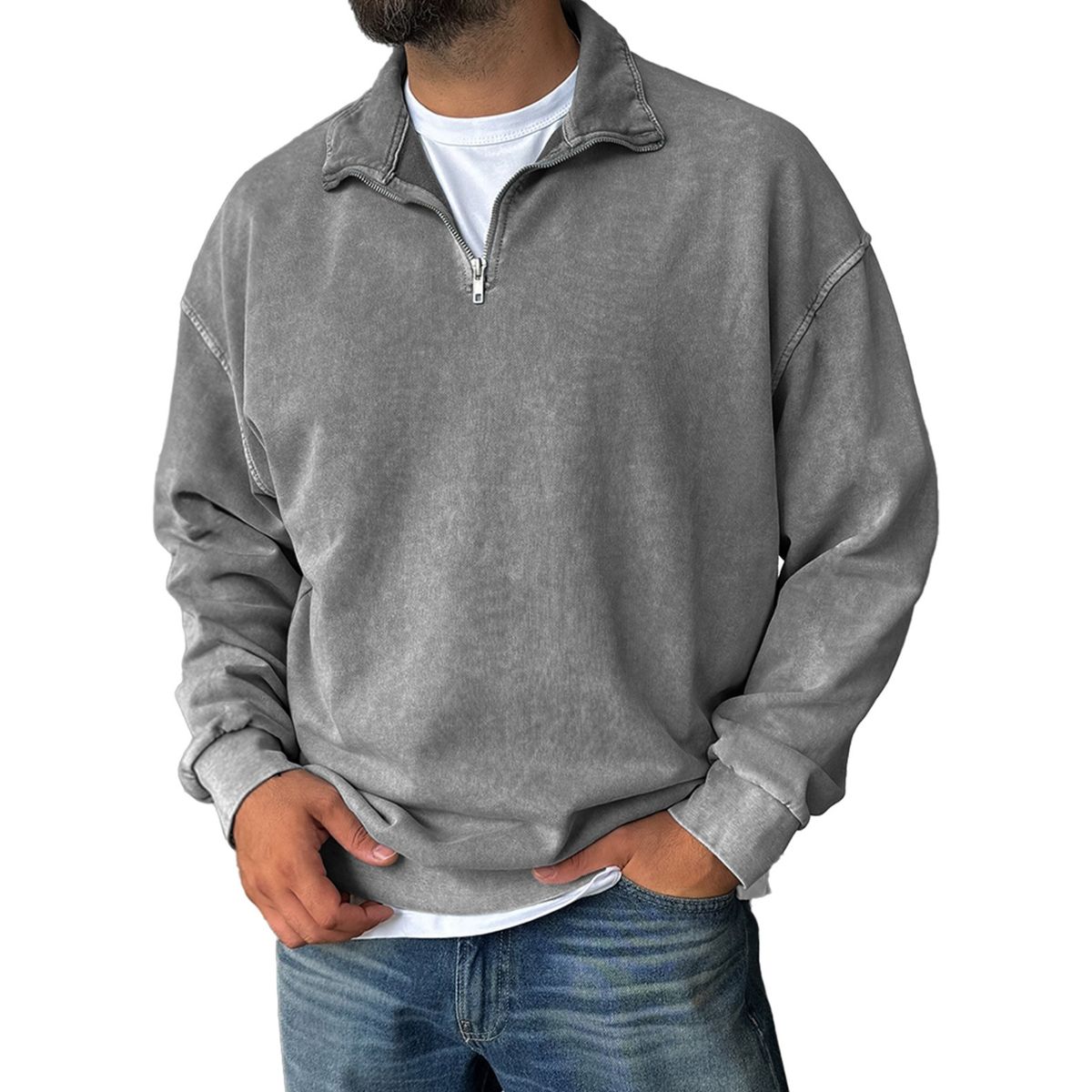Person wearing a gray quarter-zip sweatshirt on a white background