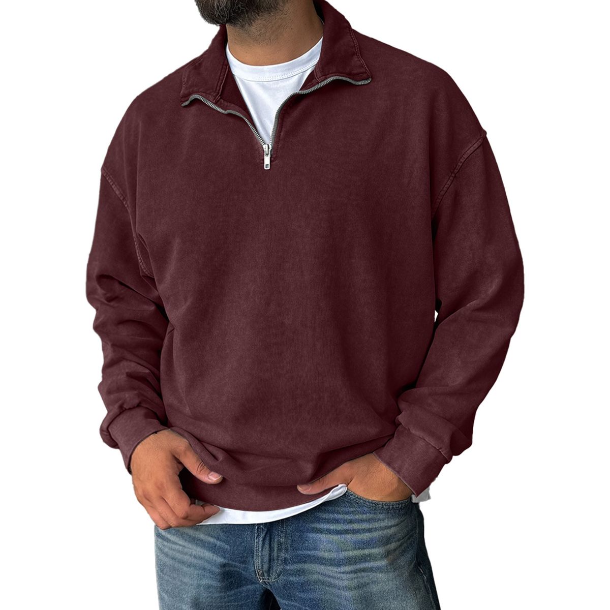 Man wearing a maroon pullover with a zipper on a white background