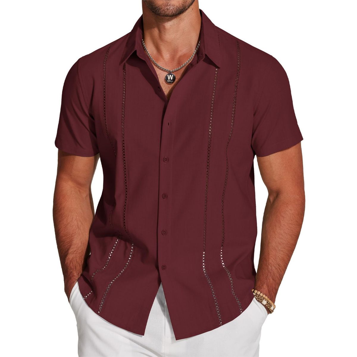 Man wearing a maroon short-sleeve shirt with decorative stitching on a white background