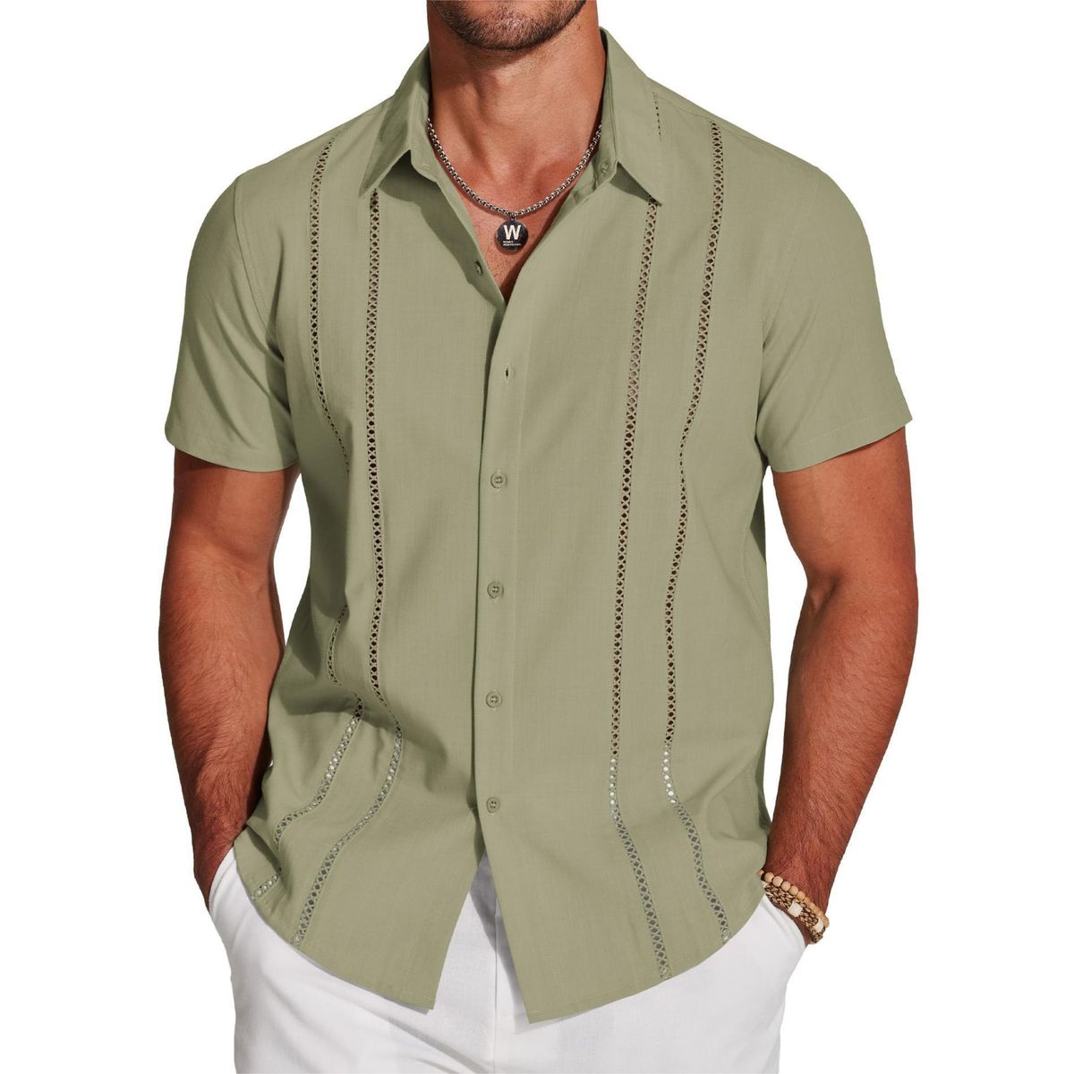 Man wearing a green short-sleeve shirt with decorative stitching on a white background